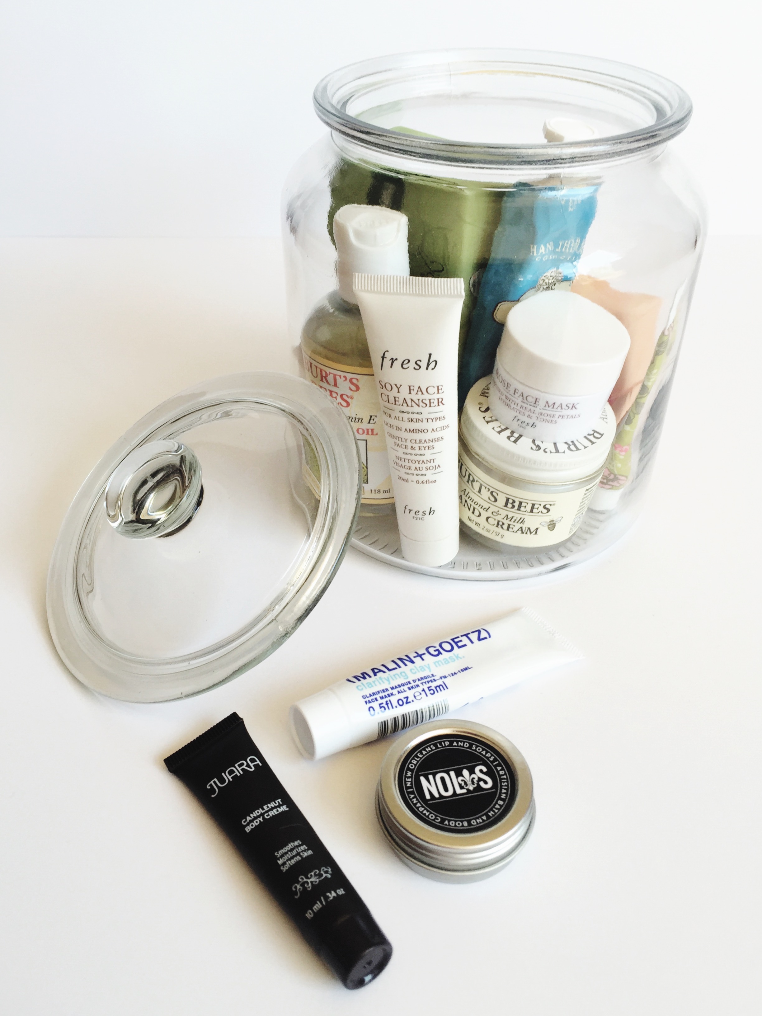 use a glass jar to corral small beauty products. it's both functional and pretty.