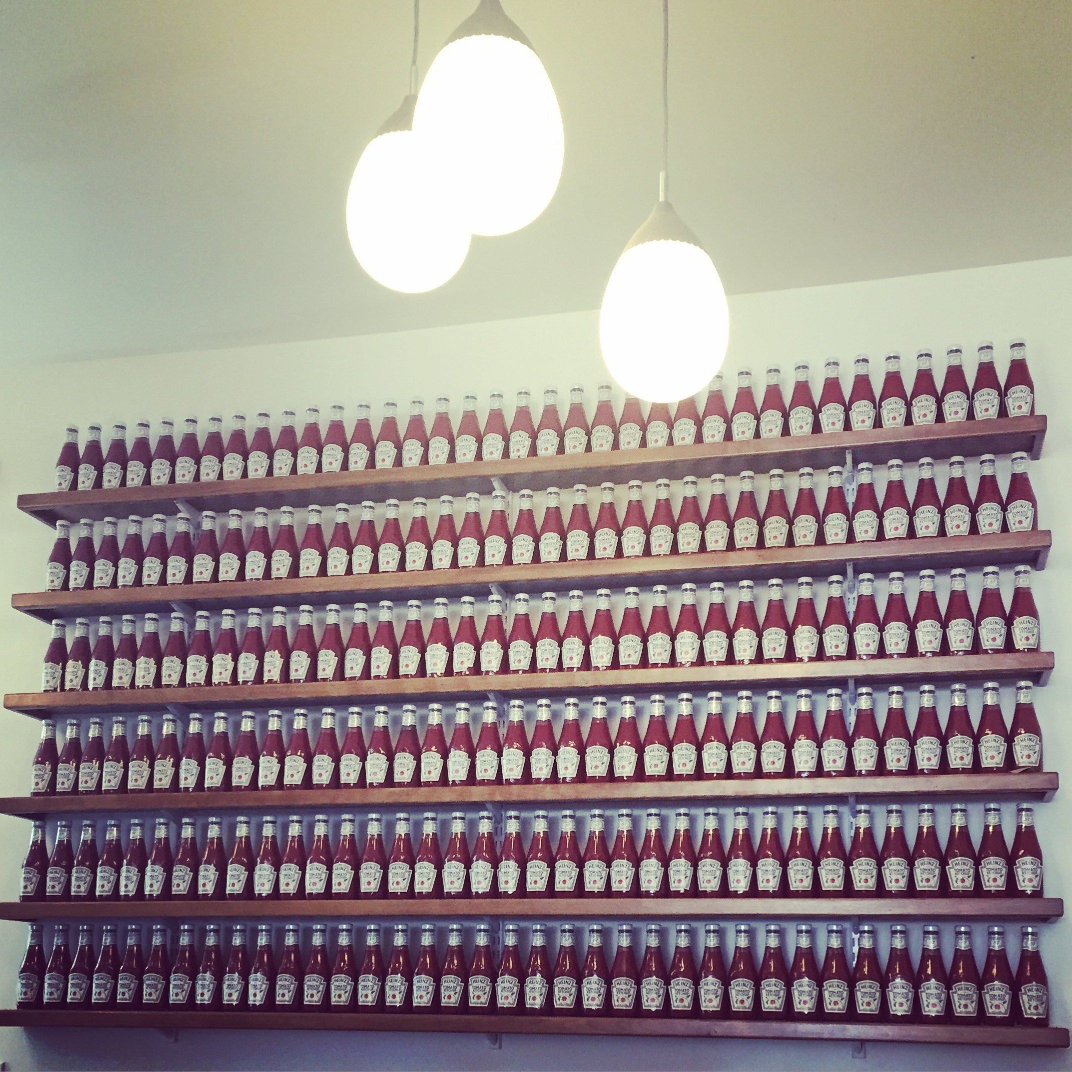 ketchup bottles on open shelving is totally art. taken at farmer boy in santa barbara, ca.