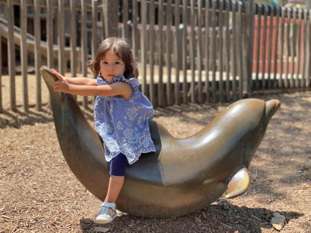 child on a dolphin statue